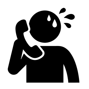 冷や汗をかいて焦りながら電話連絡をしている人のシルエット